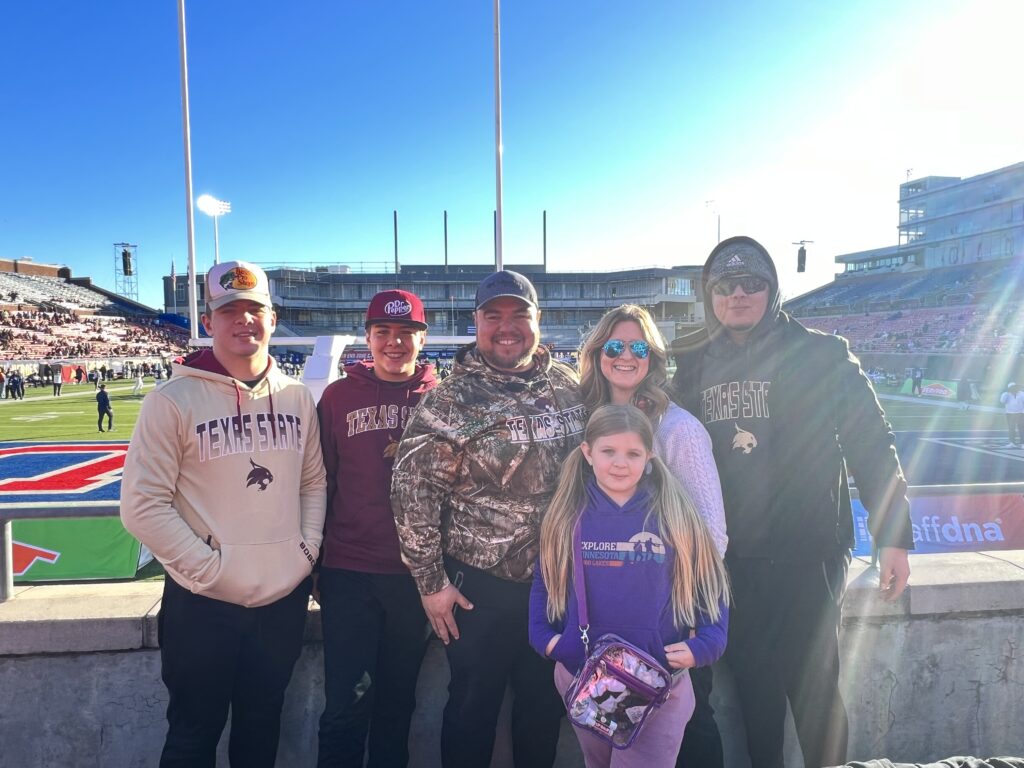 FAMILY AT COLLEGE FOOTBALL GAME